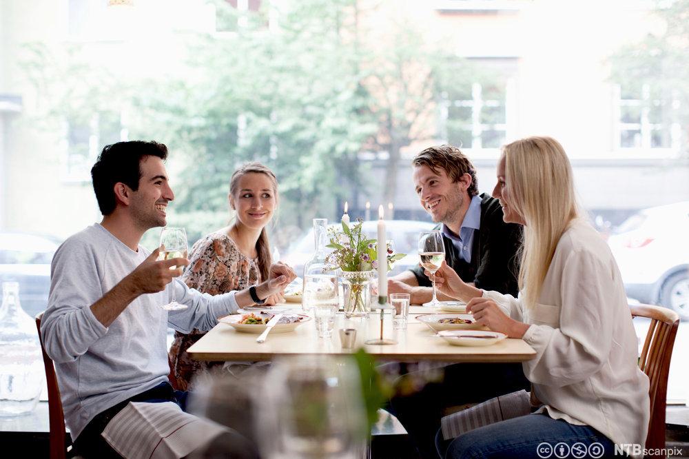 Fornøyde gjester som inntar et måltid på restaurant. Foto.