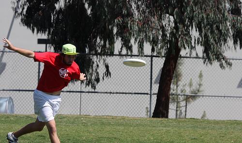Mann kastar frisbee. Foto.