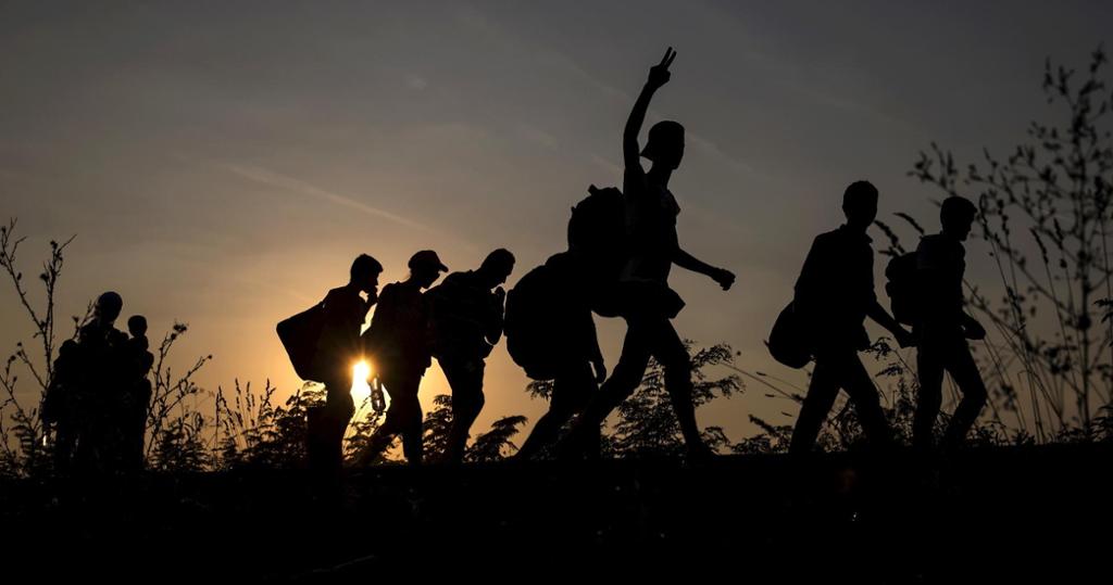 The picture shows the silhouettes 8 migrants crossing into Hungary. Photo. 