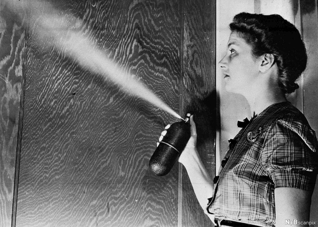 Kvinne bruker gammeldags sprayboks. Foto.