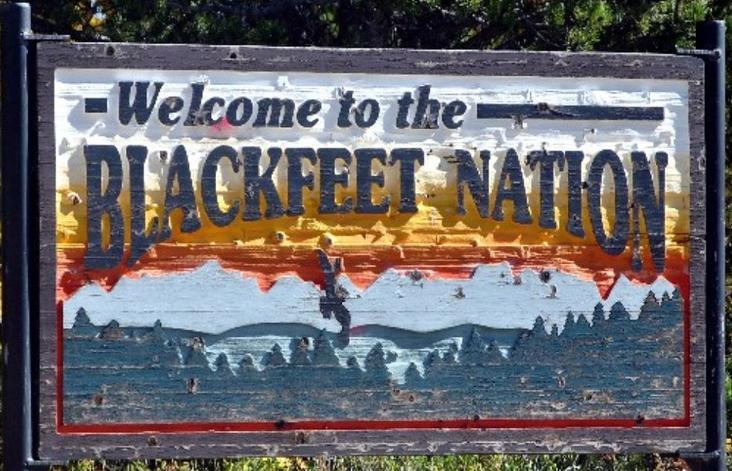 A colourful sign saying "Welcome to Blackfeet land". Photo.