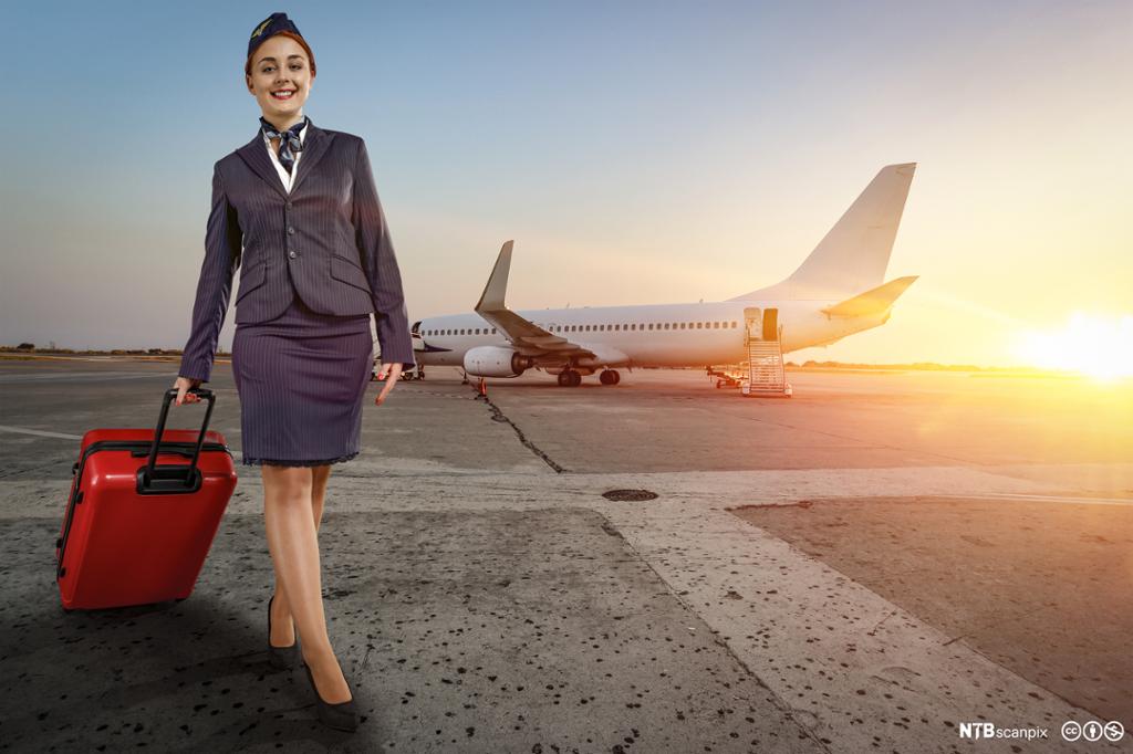 Flight attendant outside an airplane. Photo.