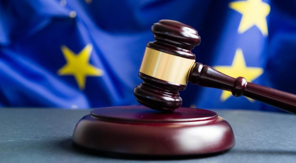En dommerklubbe i mørkt tre med gullfarget bånd som står på et bord med et EU-flagg i bakgrunnen. Foto.