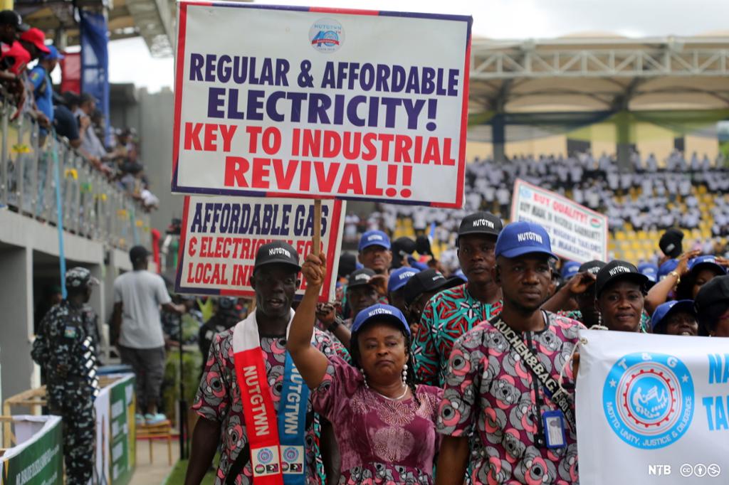 People holding up banners demanding affordable gas and electricity. Photo. 