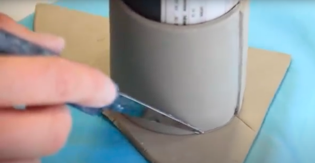 Kniv skjærer bunn til sylinderform. Foto.