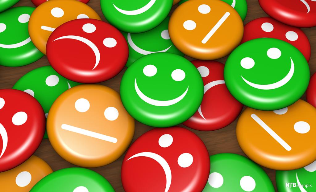 Buttons i ulike farger med glade og sure ansikter. Illustrasjon.