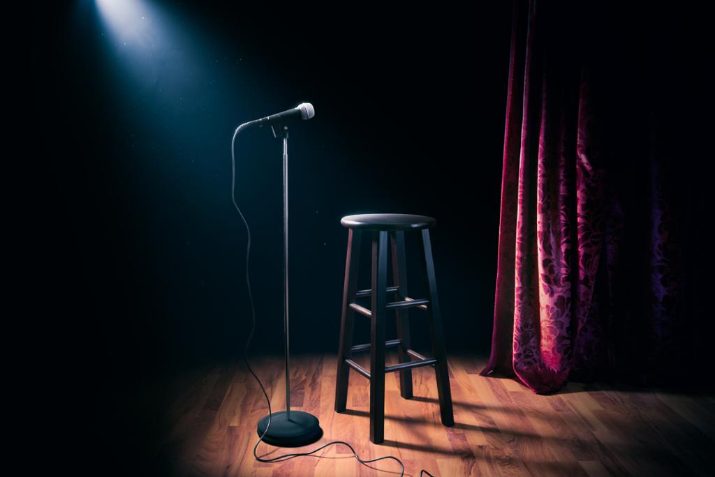 A stool and a microphone on a stage. Photo