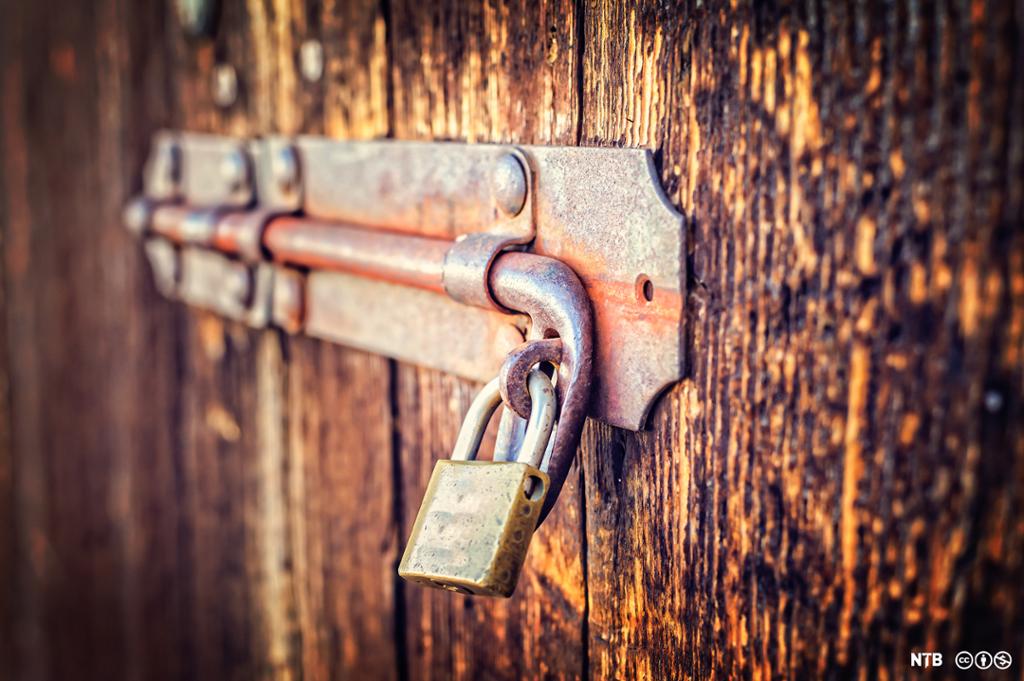 Close-up of a an old latch of an old wooden door.  