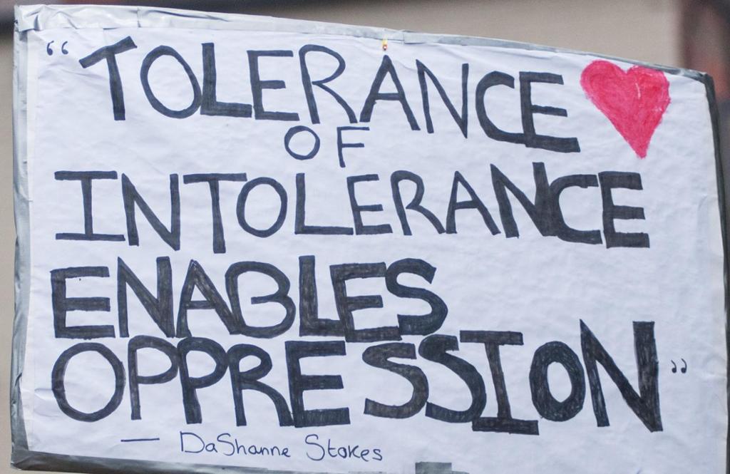 A photo from a demonstration. People holding a sign saying "Tolerance of intolerance enables oppression"