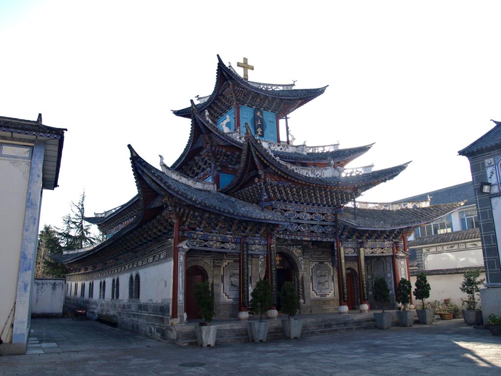 Bygning i kinesisk arkitektur med kross på taket. Foto.