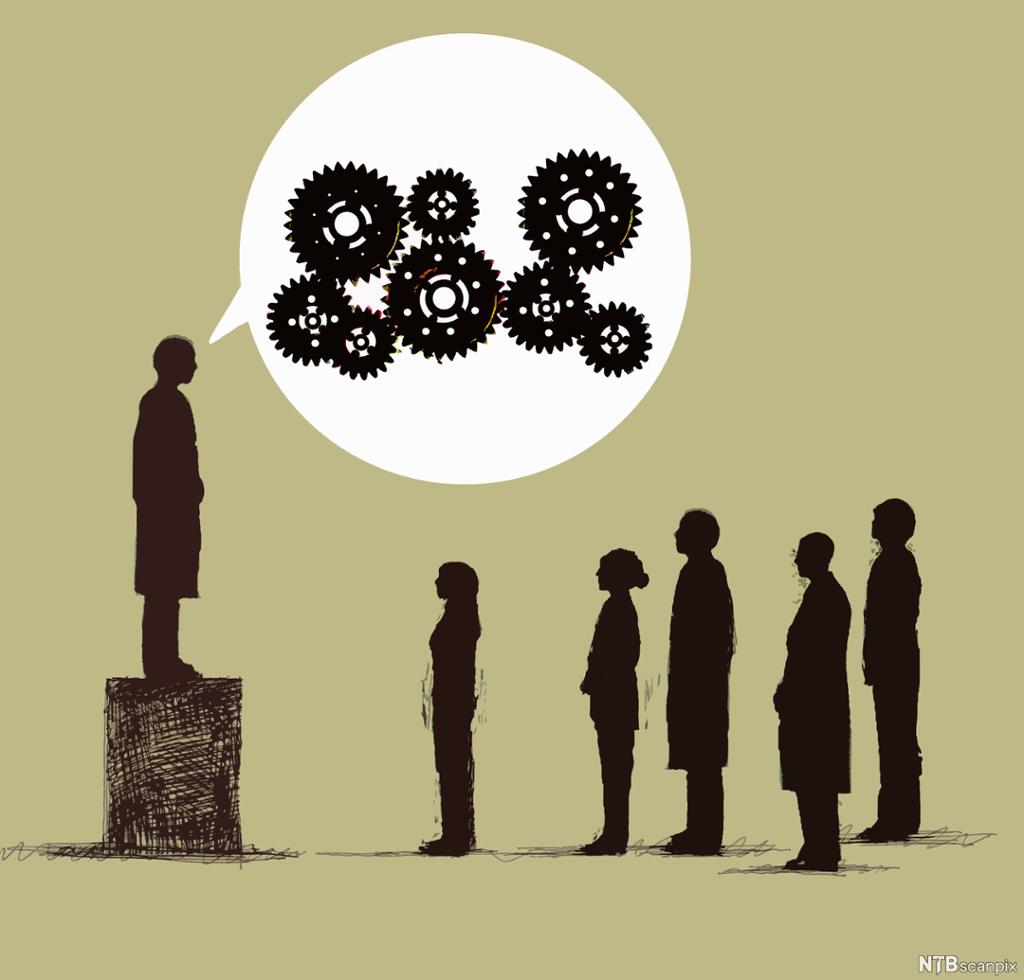 Man on box talking to audience,  cogs in speech bubble. Five people stand in front of him. 