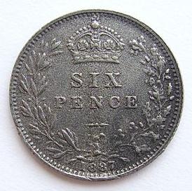 A photo of a British sixpence from 1897. The head of Queen Victoria is on one side of the coin. 