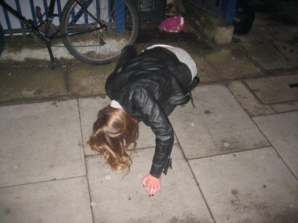 Teenage girl falling on pavement. Photo.
