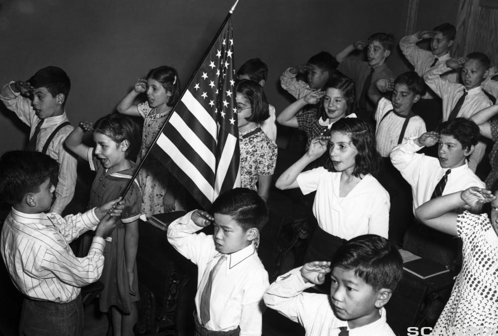 Children in New York with roots in many different cultures saluting the American flag