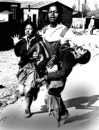 A photo taken during the Soweto uprising of 1976. The 13-year-old Hector Pieterson has been shot by the police and is being carried away by an older boy. His sister is running alongside. 