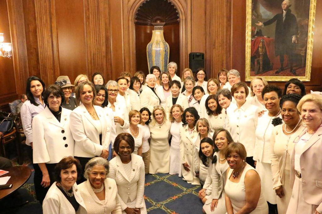 Congresswomen Pelosi joins her House Democratic Women Representative colleagues by wearing white in a powerful show of unity to honor women’s suffrage – a symbol of purity supporting the defense on women’s rights.