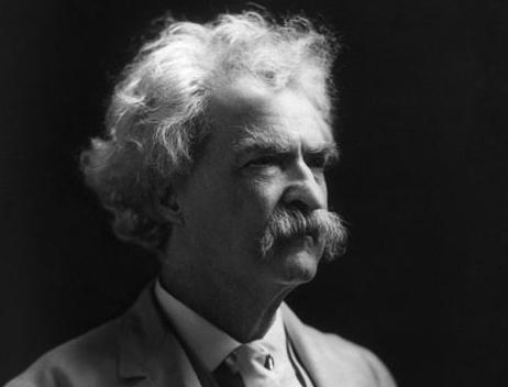Photograph of Mark Twain, an older man with bushy white hair, eyebrows and moustache. 