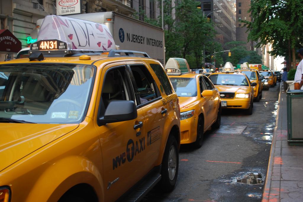 Yellow taxis in a long line. 