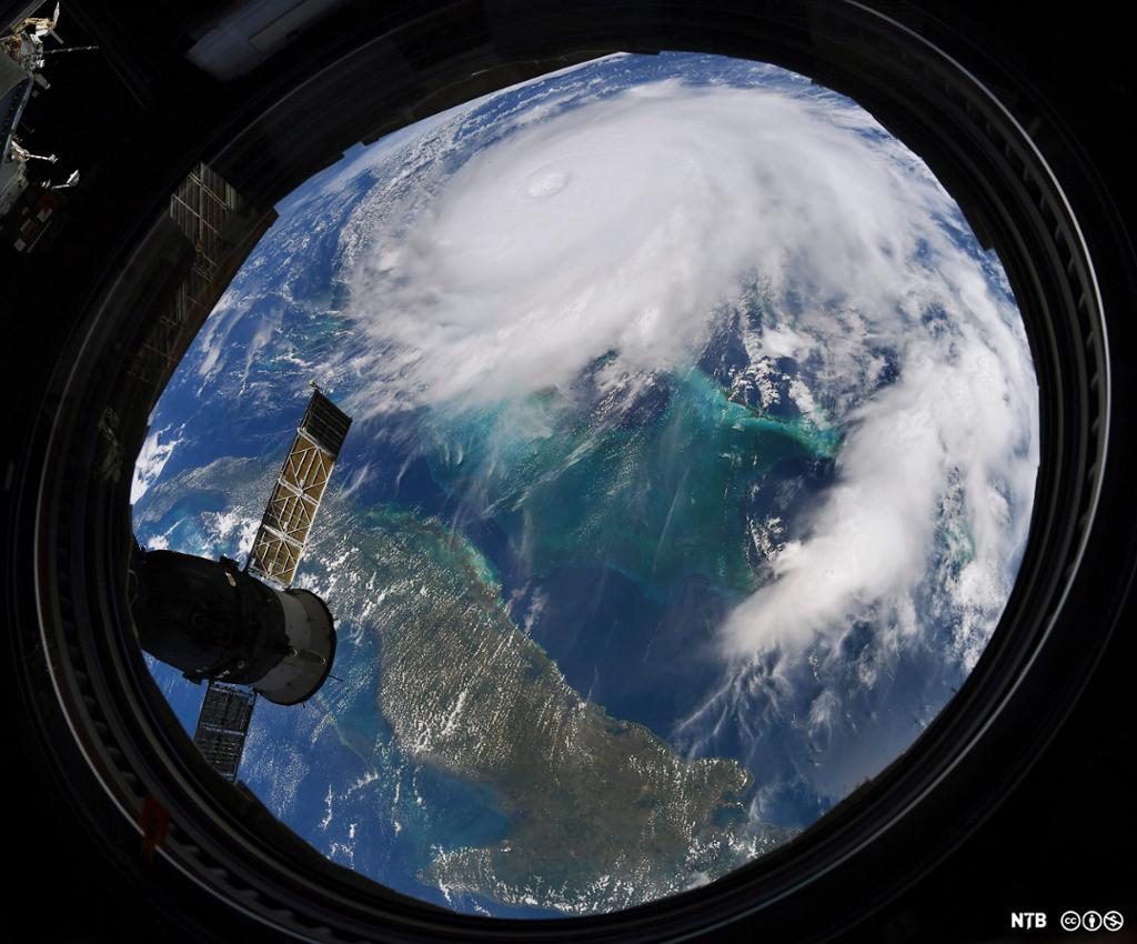 Photo: The Earth seen from a structure in space. We see a hurricane moving towards a land mass. 
