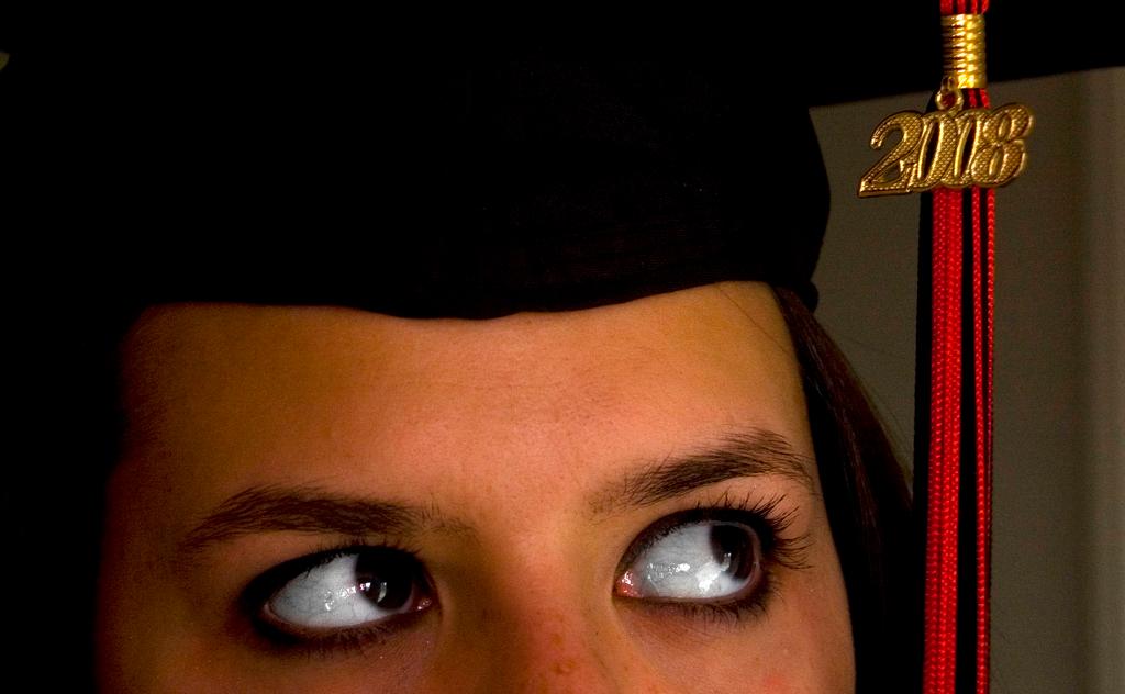 Top of girl's head with graduation cap. Photo.