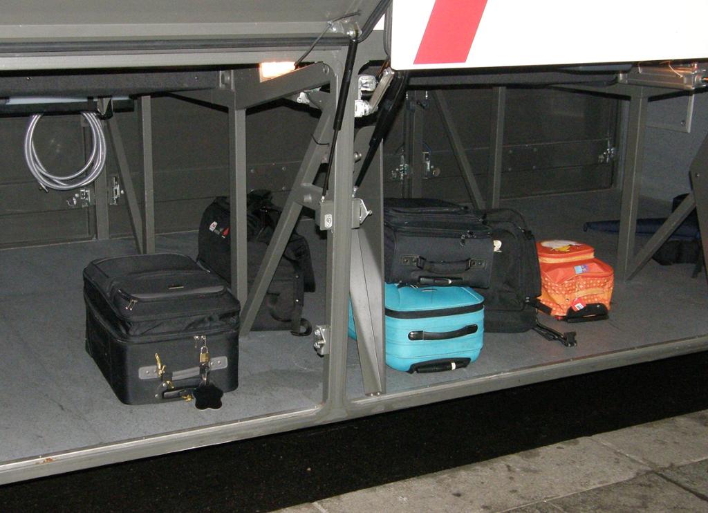 Koffertar i bagasjerommet på ein buss. Foto.