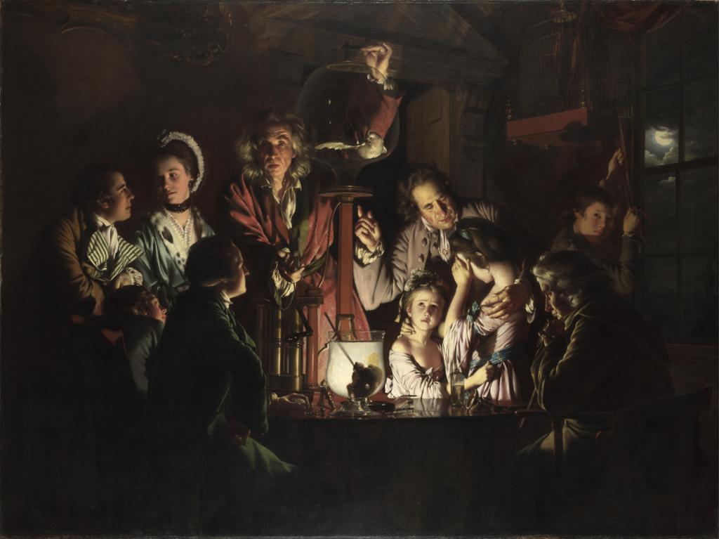 Painting: A group of people are gathered, they are watching an experiment. The room around them is dark. They appear to be lit up by light coming from the apparatus used in the experiment. Women, men and children are present. Most appear to be dressed in a lavish, expensive style. 