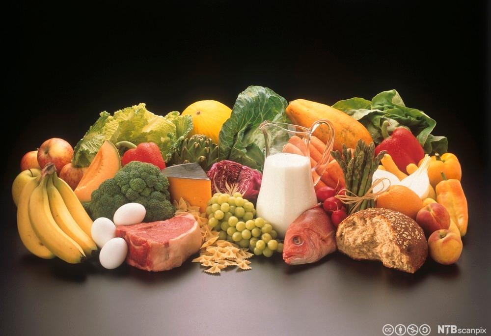 Frukt, grønnsaker, fisk, kjøtt og egg ligger på et bord. Foto.