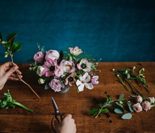 Hender som jobber med blomster. Foto.