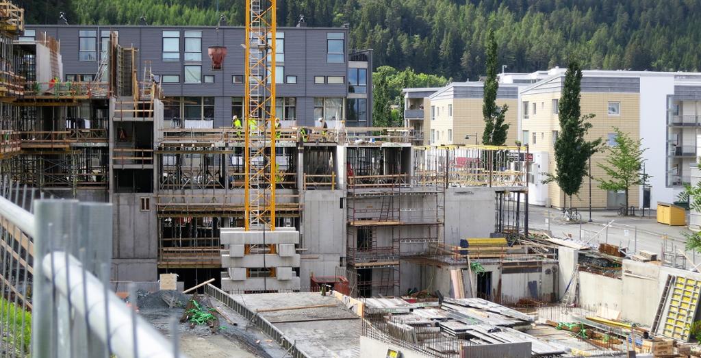 Boligblokk bygges foran flere boligblokker. Foto.