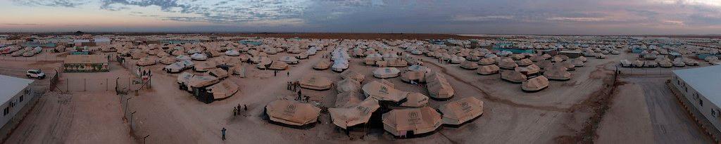 A panorama picture of a refugee camp filled with tents.