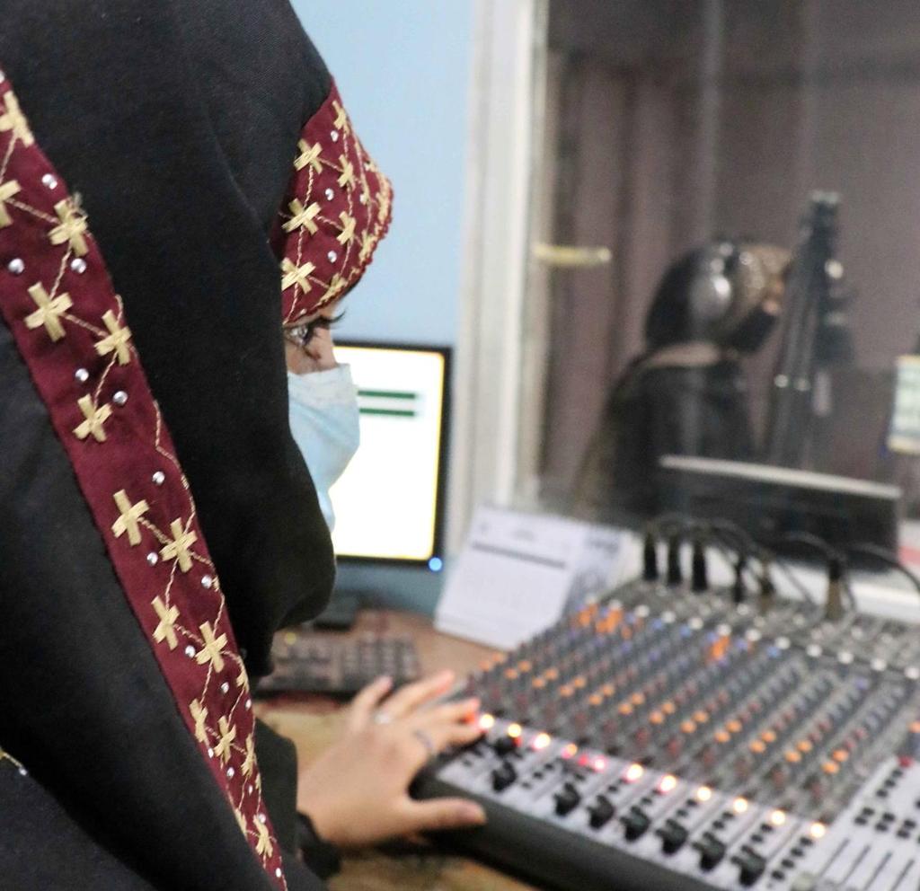 Kvinnelig radiojournalist med nikab produserer radiosending. Foto.
