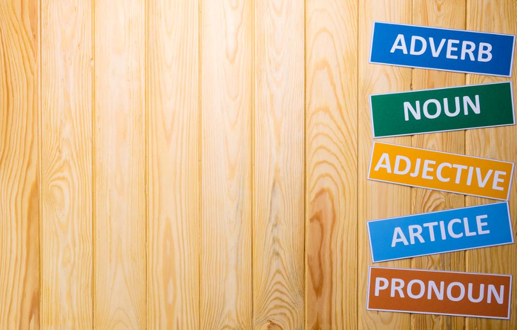 English word classes on a wooden background. Photo.