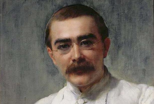 Painting: Portrait of Rudyard Kipling. We see a man in his late twenties. He has brown hair, bushy eyebrows and a large moustache. He wears gold-rimmed spectacles. He wears a white shirt.