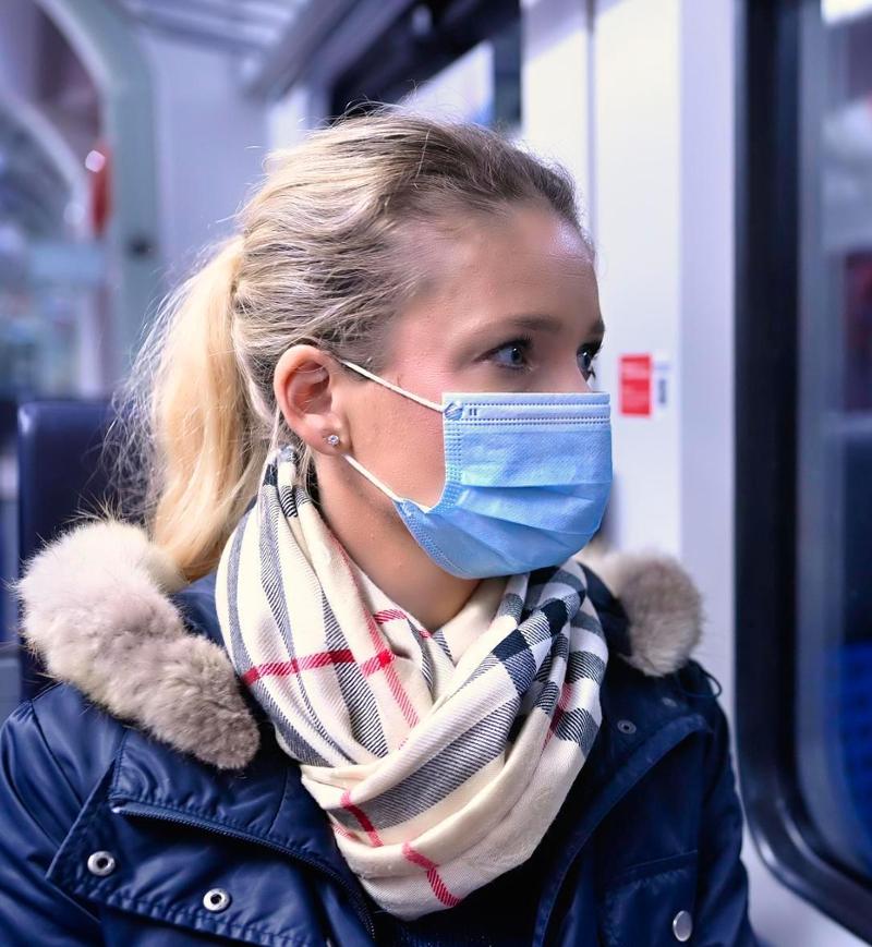 Woman with a face mask sitting in a train, reflected in the S-Bahn, Corona crisis, Stuttgart, Baden-Württemberg, Germany, Europe