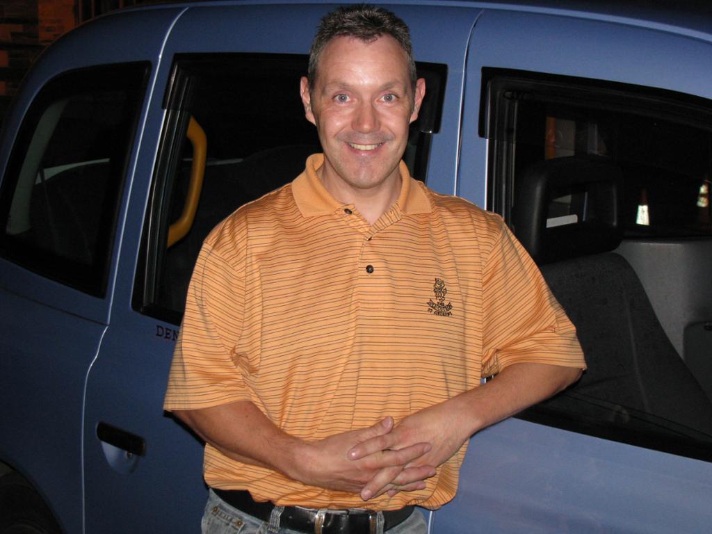 Person standing near a car. Photo.