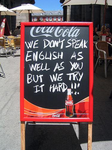 Sign with text saying: We don't speak English as well as you but we try it hard!!!". Photo.