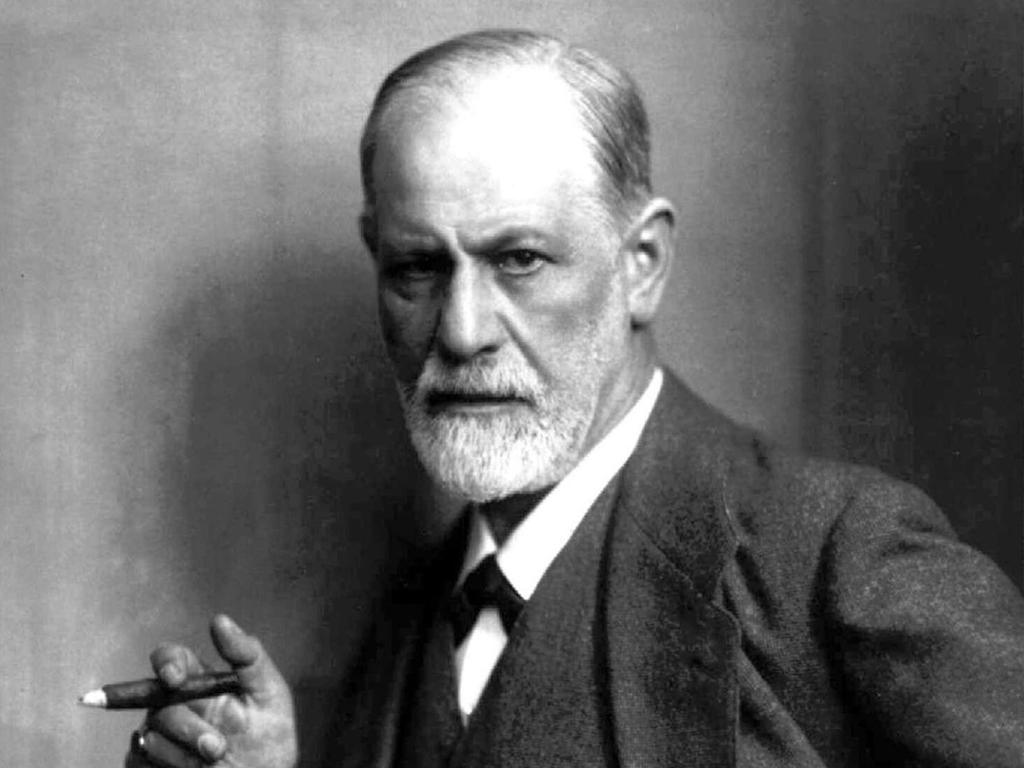 Portrettbilde av Sigmund Freud med en sigar i hånda. Han har skjegg, er kledd i jakke, vest og skjorte og har et alvorlig ansiktsuttrykk. Foto.