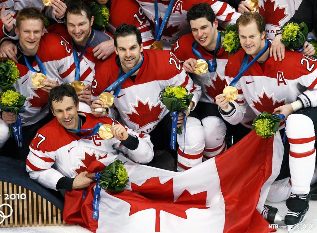 The Canadian men's hockey team pose with their gold medals at the Vancouver 2010 Winter Olympics