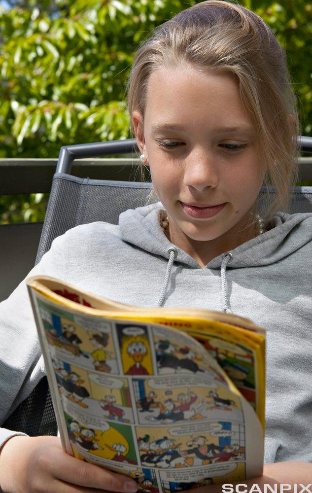 Picture of girl reading comics.