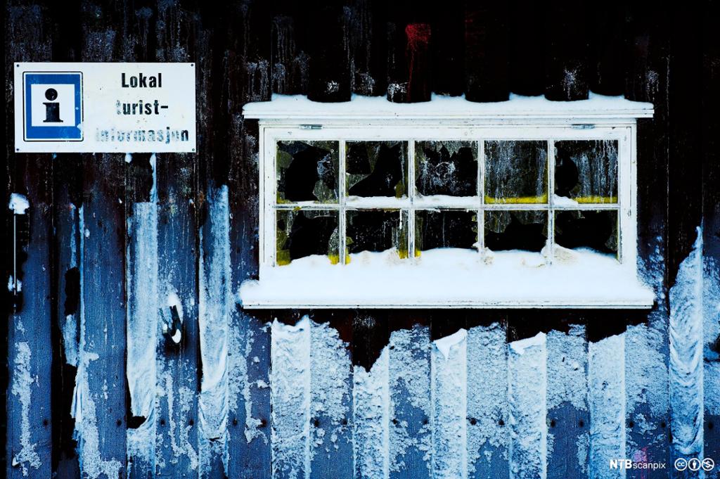Snødekt hyttevindu. Skilt med turstinformasjon. Foto.