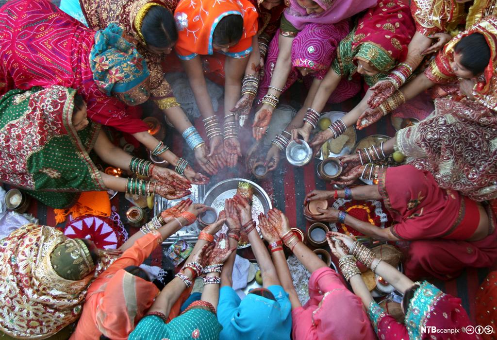 Women pray during the Hindu festival of Karva Chauth inside a temple in the northern Indian city of
    Chandigarh