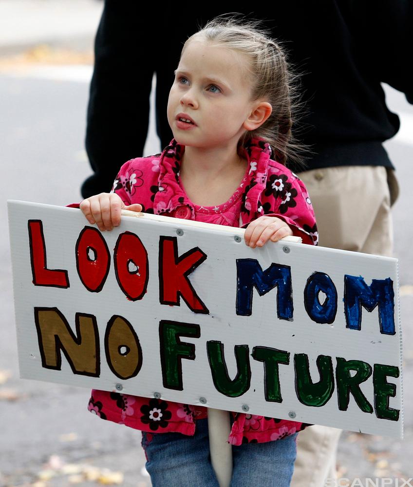 Abigail Garrett, 6, of Hamden, Connecticut holds a sign during an Occupy Wall Street protest.