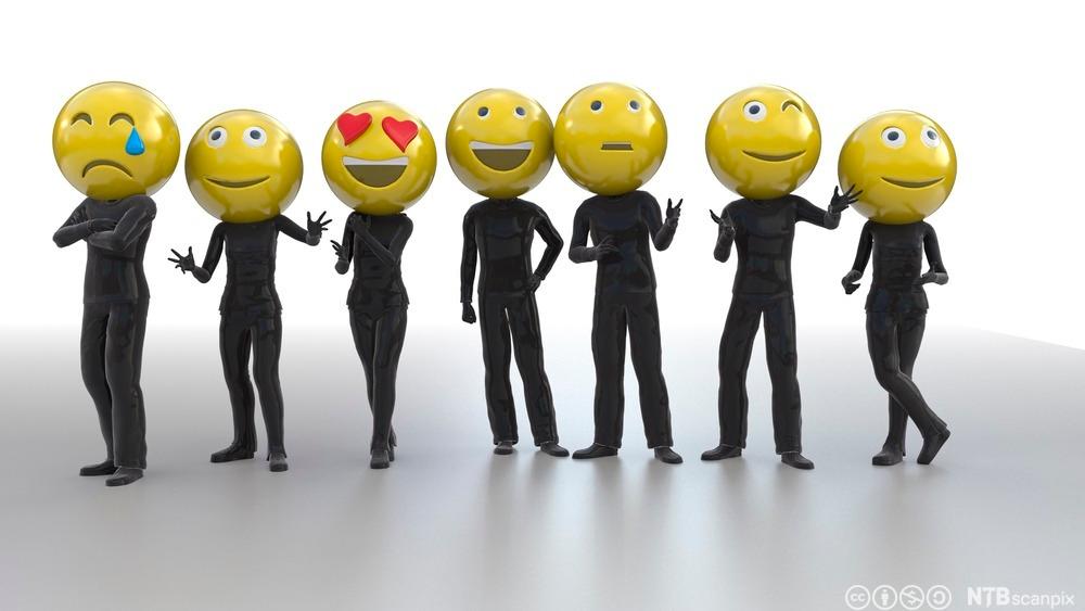 Photo: People dressed in black with emoticon faces. 