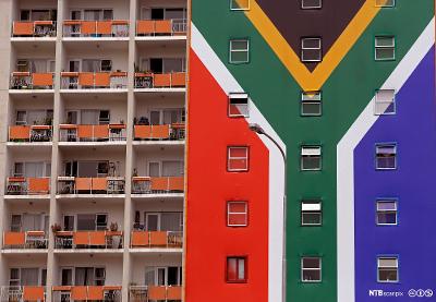 A South African flag banner on the side of an apartment block in the city of Cape Town