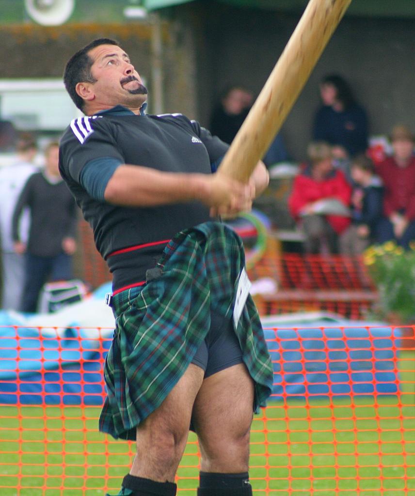 A man tossing a caber. Photo.