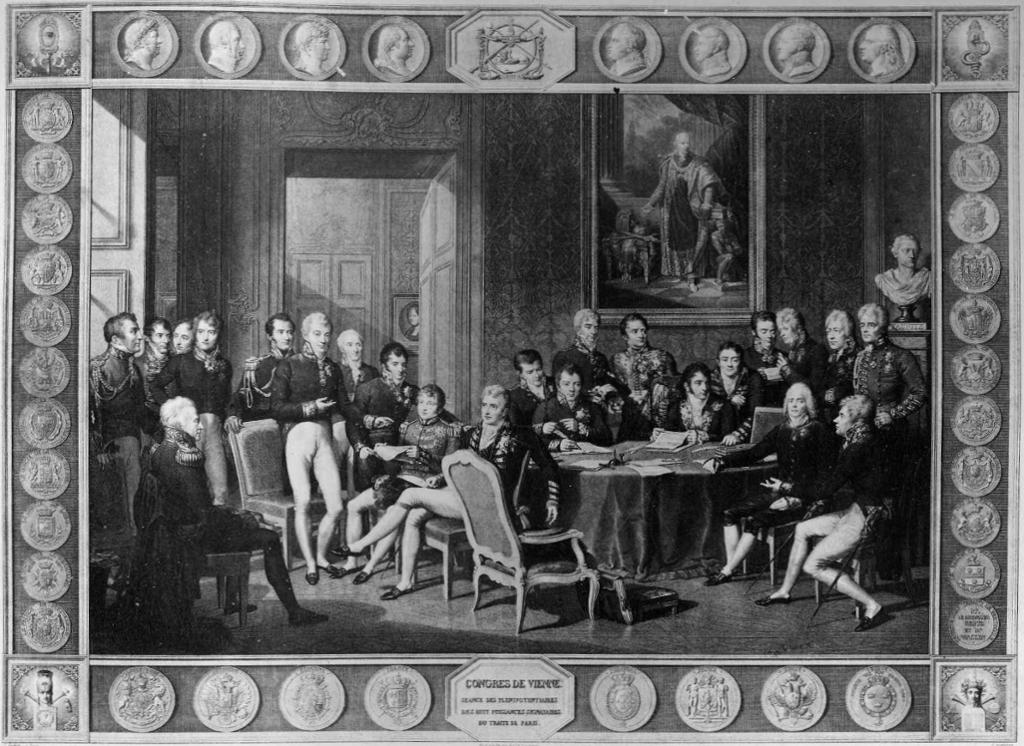 Europeiske diplomater og politikere samlet i et rom rundt et bord tidlig på 1800-tallet. De fleste har uniformer med knebukser til. Maleri.