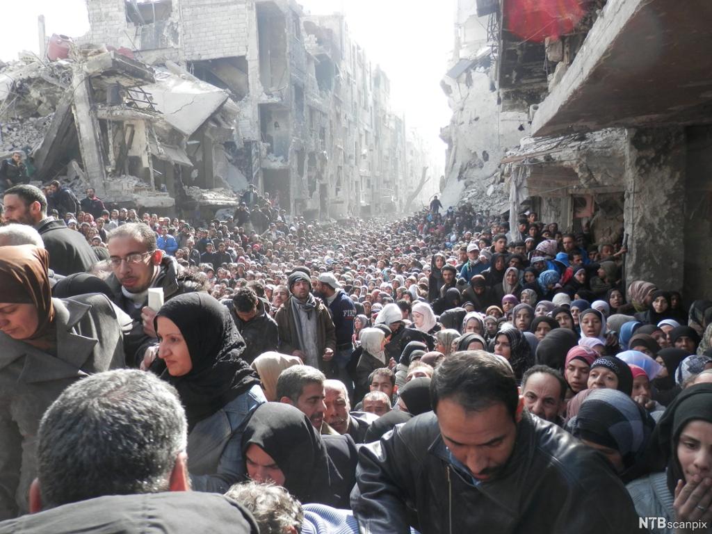 Palestinske flyktninger venter på matvarehjelp i Yarmouk-leiren i utkanten av Damaskus. Foto